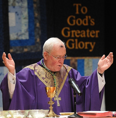 Bishop Richard J. Malone blesses the hosts for communion during Ash Wednesday Mass at Canisius High School. (Dan Cappellazzo/Staff Photographer)